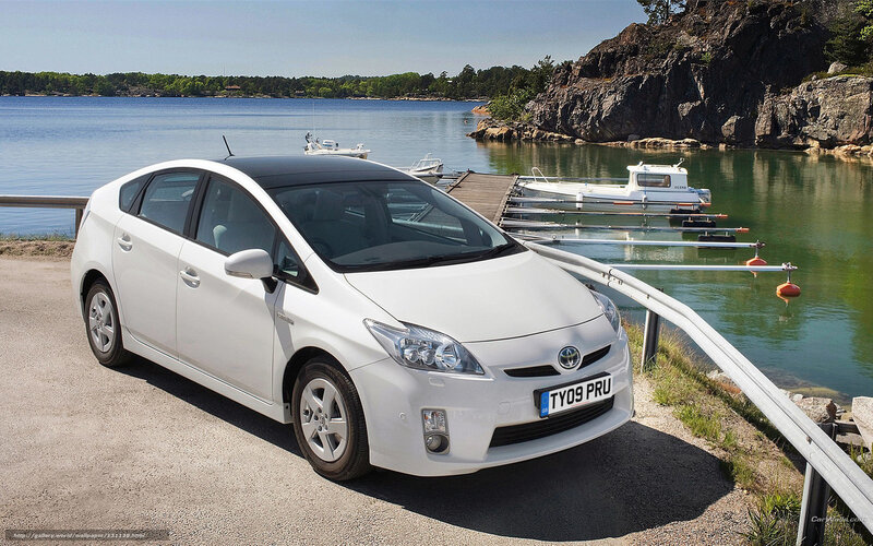 White Toyota Prius by the water