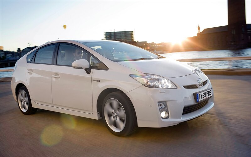 White Toyota Prius driving on bridge