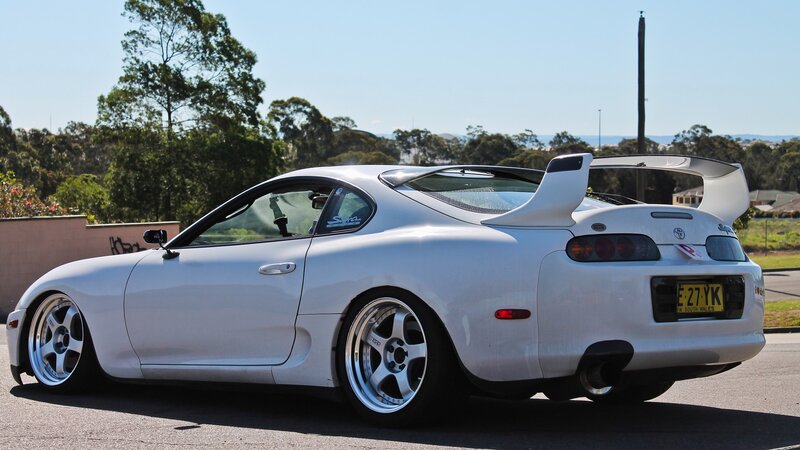 white toyota supra with rear wing