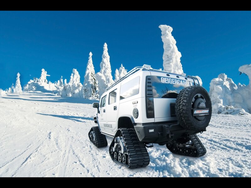 White tracked vehicle in snowy landscape