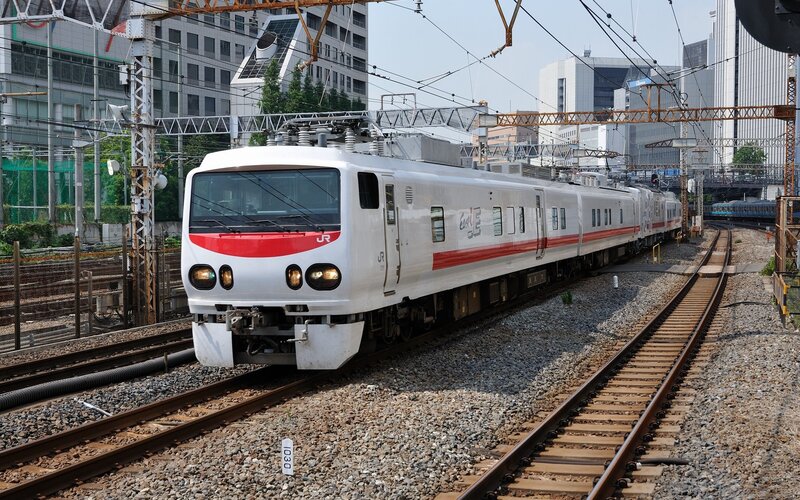 White train on city tracks