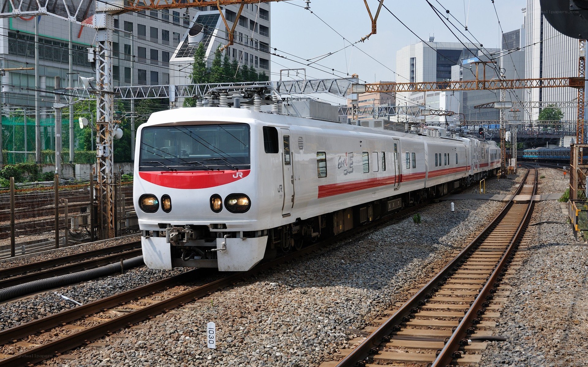 White train on city tracks