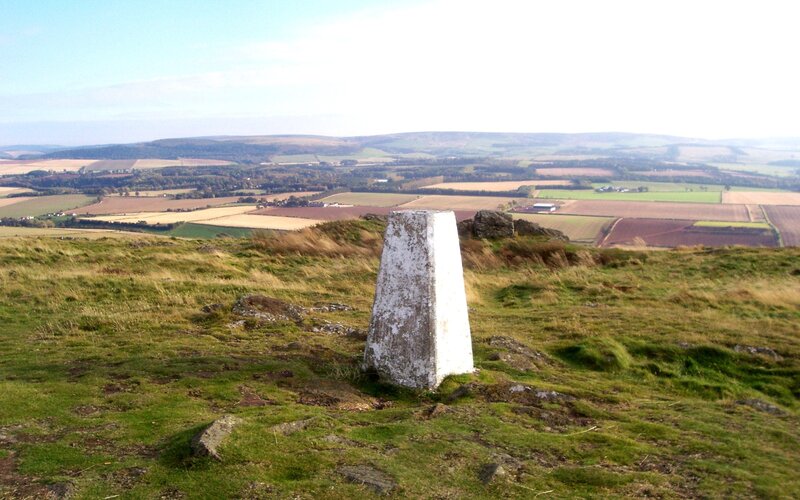 White trig point on a hill