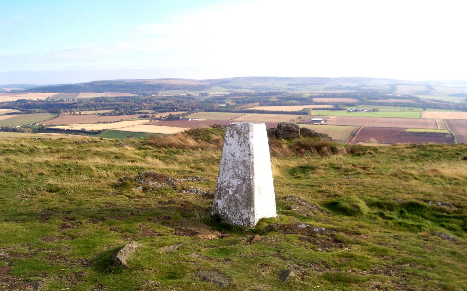 White trig point on a hill