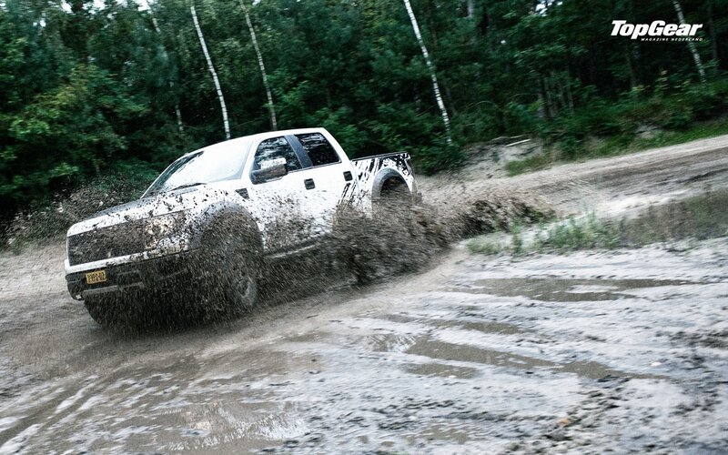 white truck driving through mud