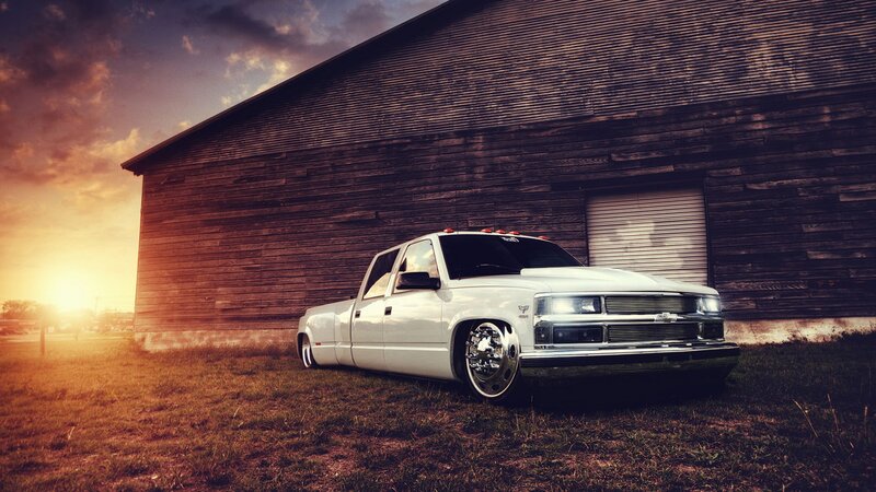 White truck in front of barn