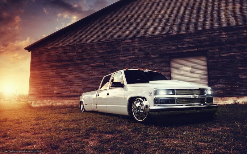 White truck in front of barn