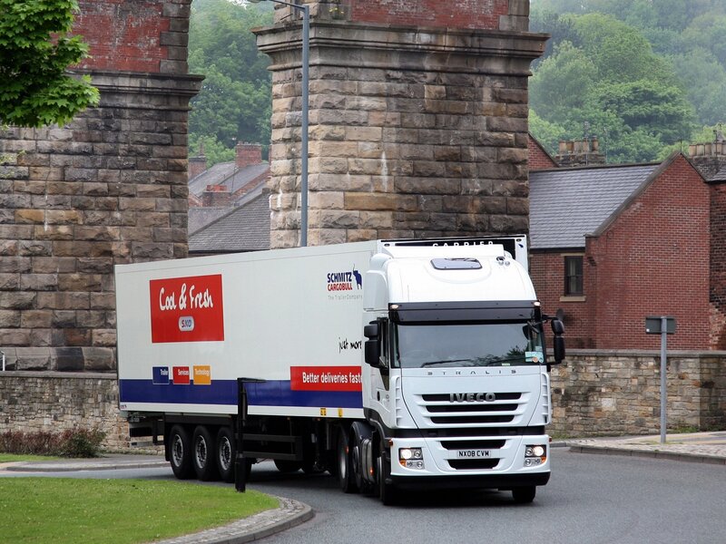 White truck passing under bridge