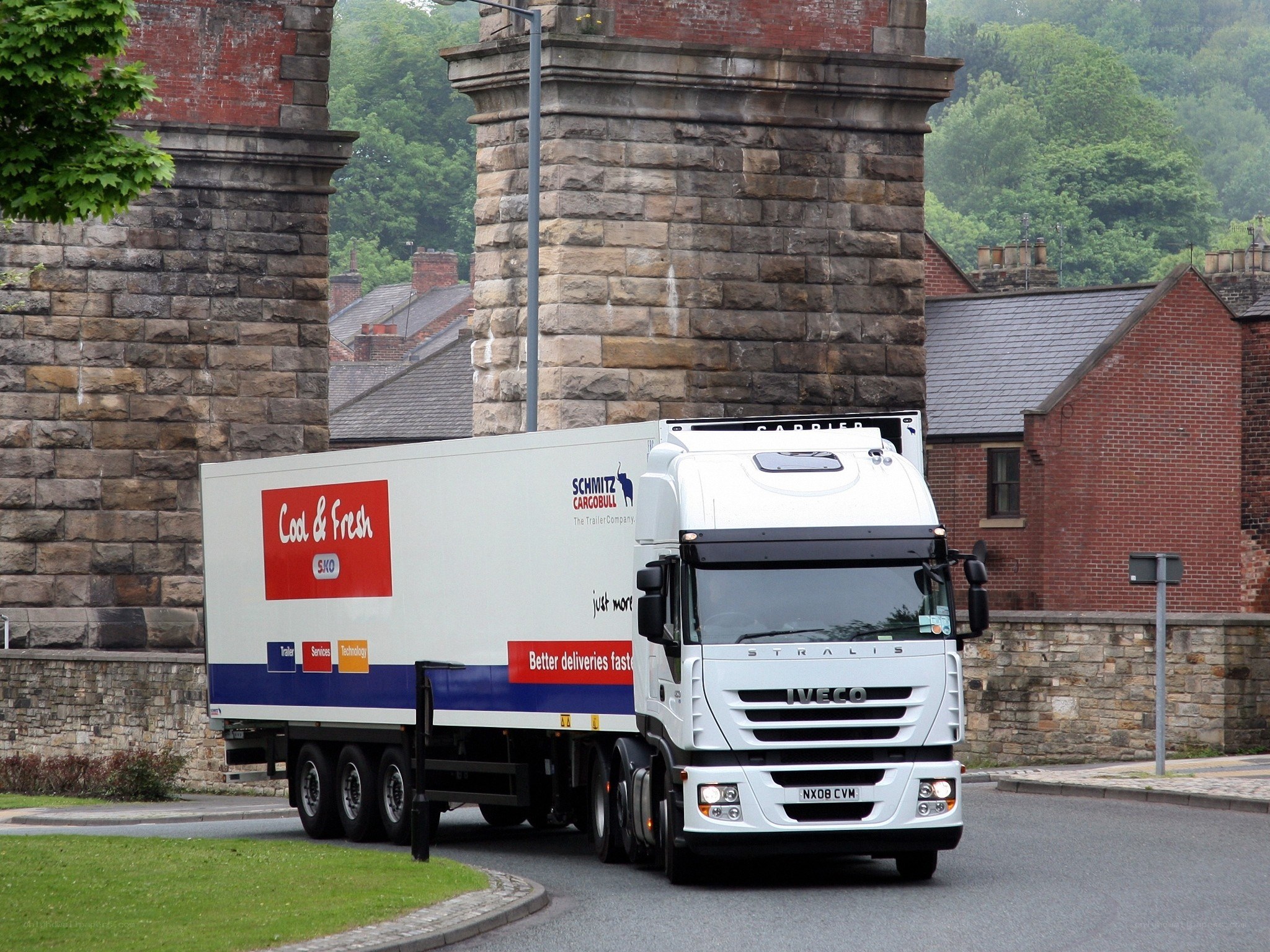 White truck passing under bridge