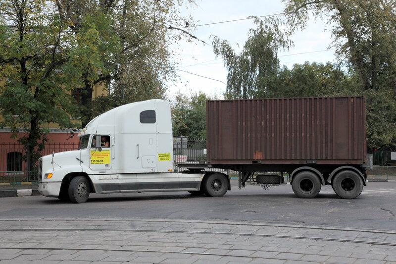 White truck with shipping container