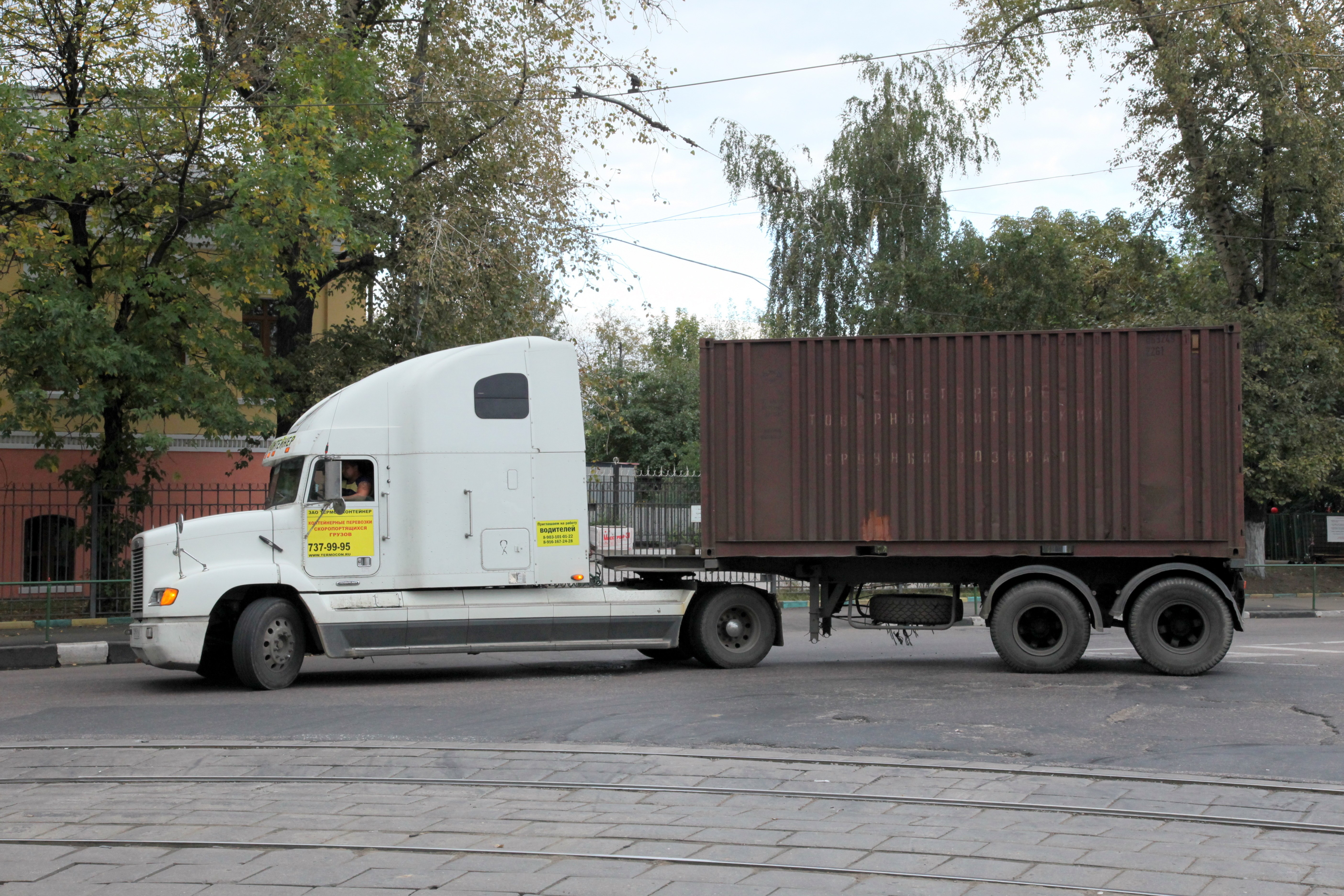 White truck with shipping container
