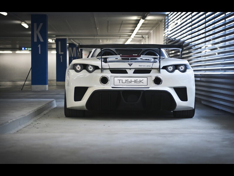 White Tushk car in parking garage