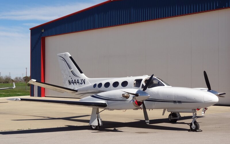 White twin-engine airplane parked