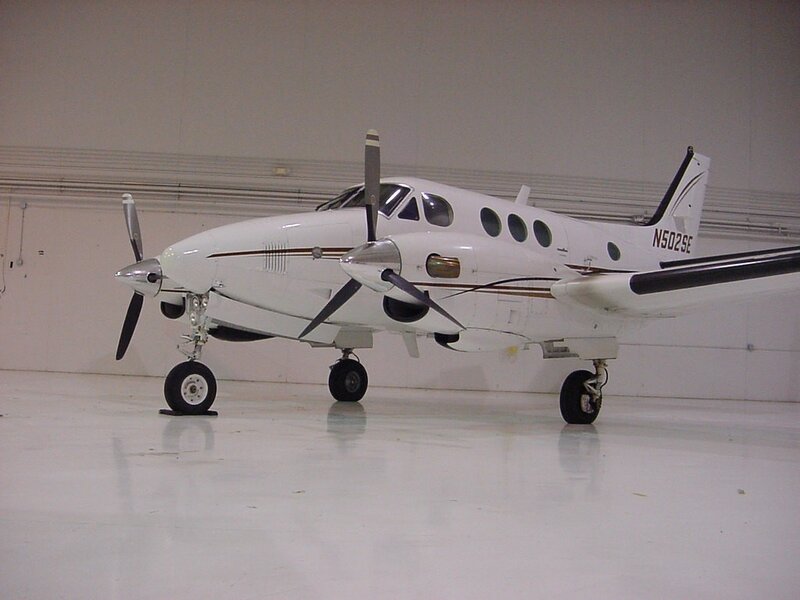 white twin-engine propeller plane