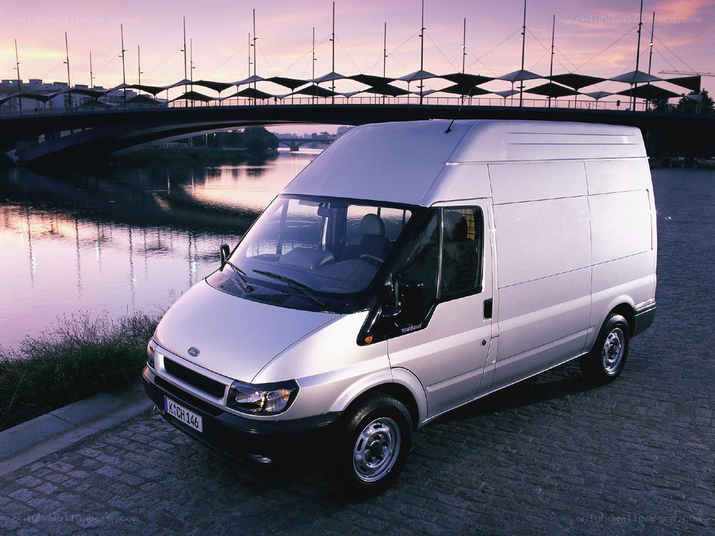 White van by a river at dusk
