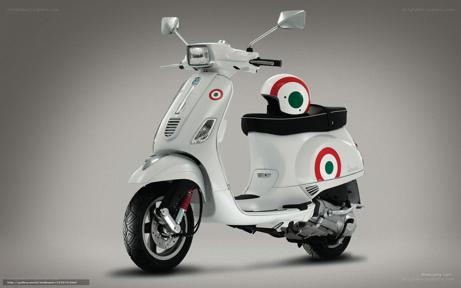 White Vespa scooter with helmet