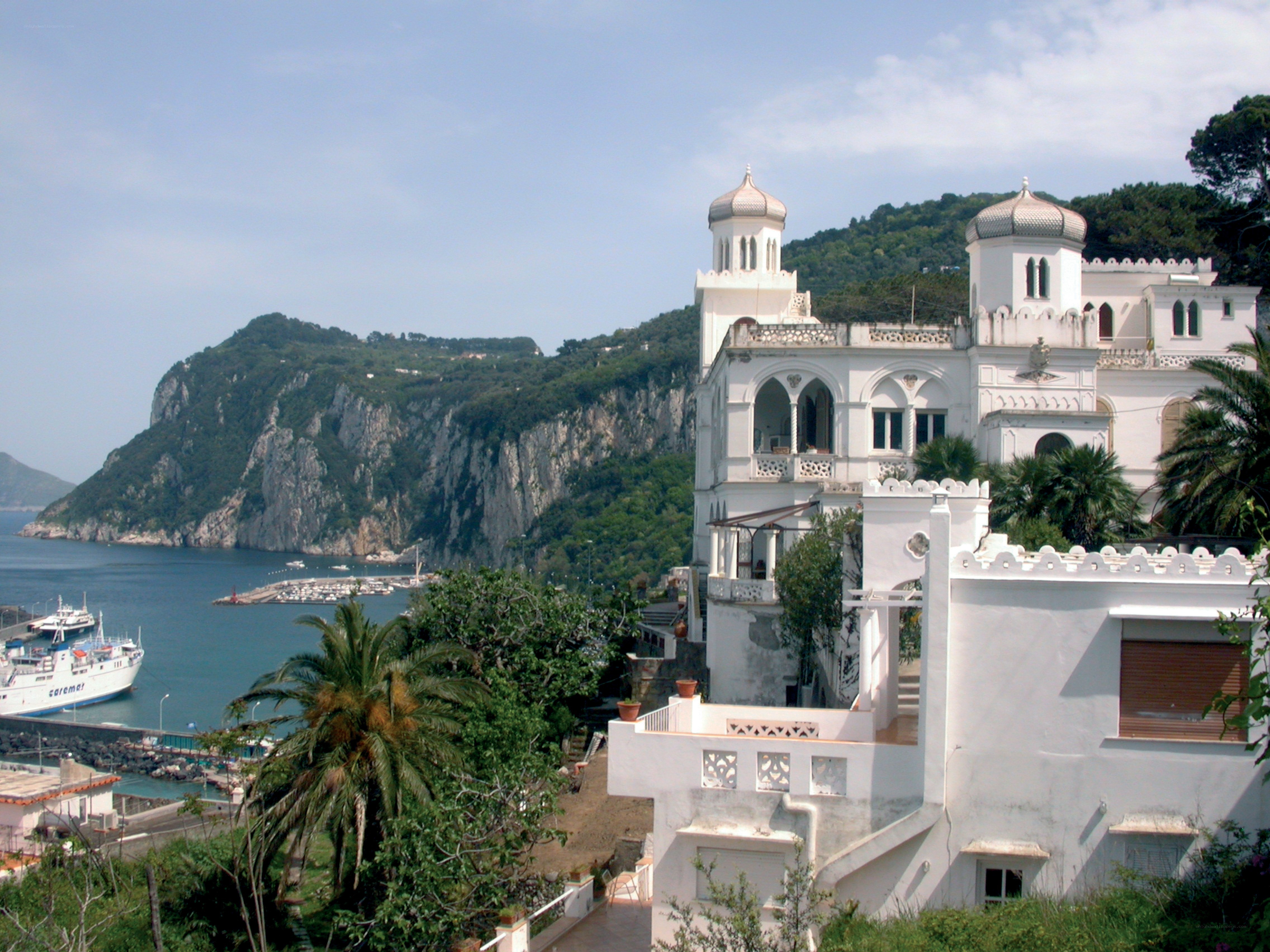White villa overlooking coastal harbor
