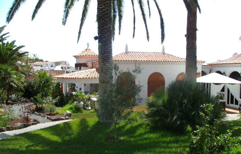 White villa with palm trees