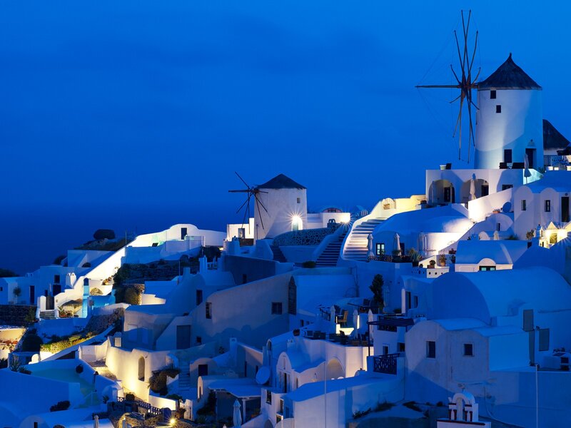 White village at dusk with windmills