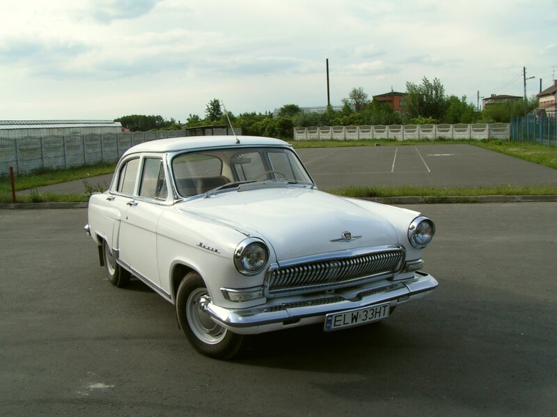 White vintage car in parking lot