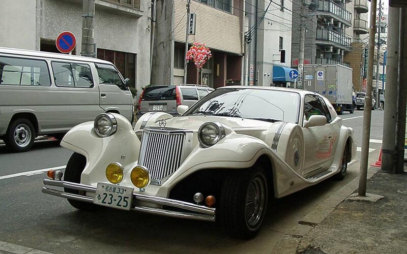 White vintage car on city street