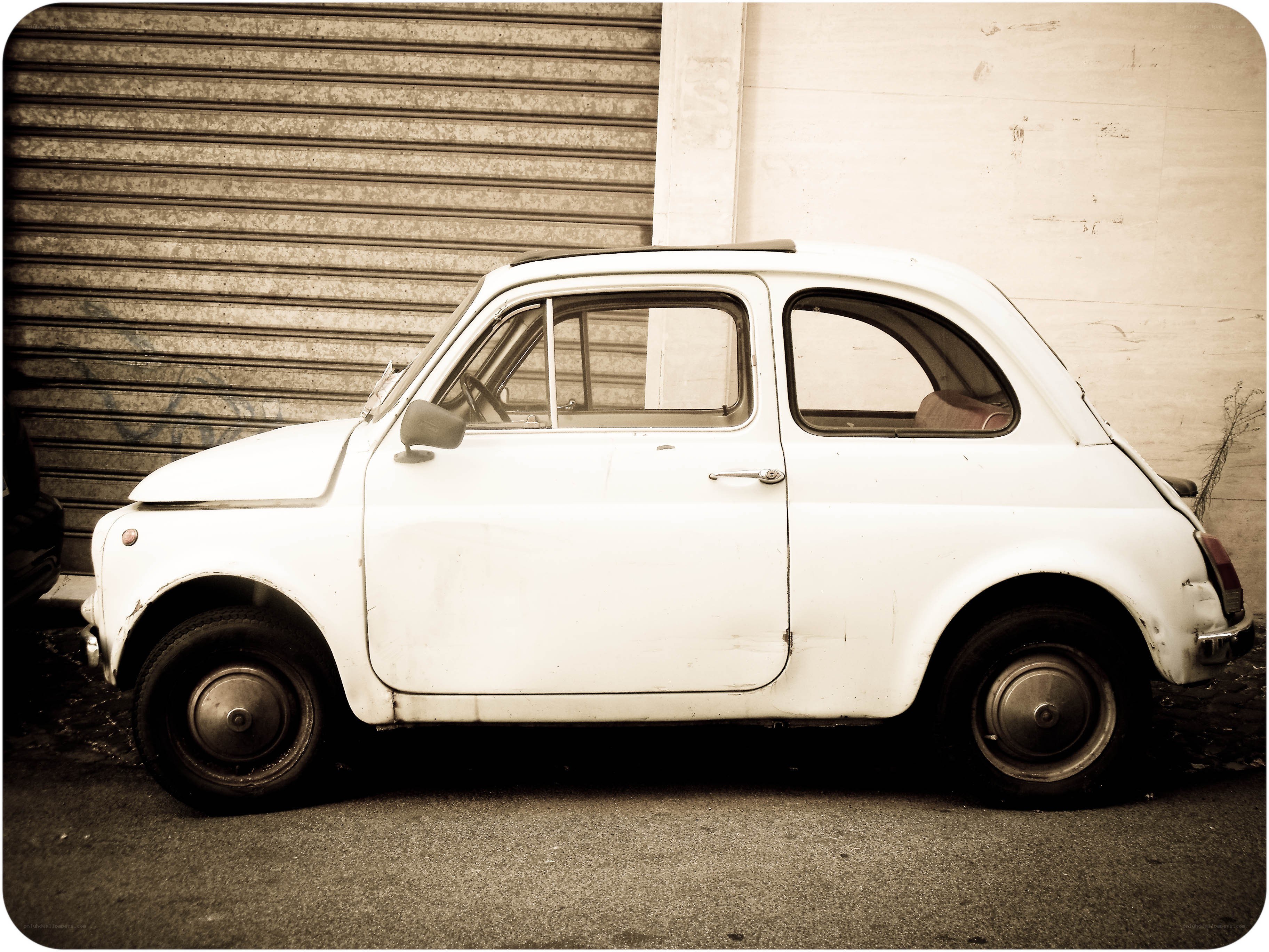 white vintage car parked outside