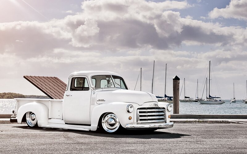 White vintage GMC truck at marina