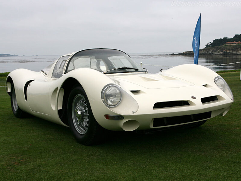 White vintage race car on grass