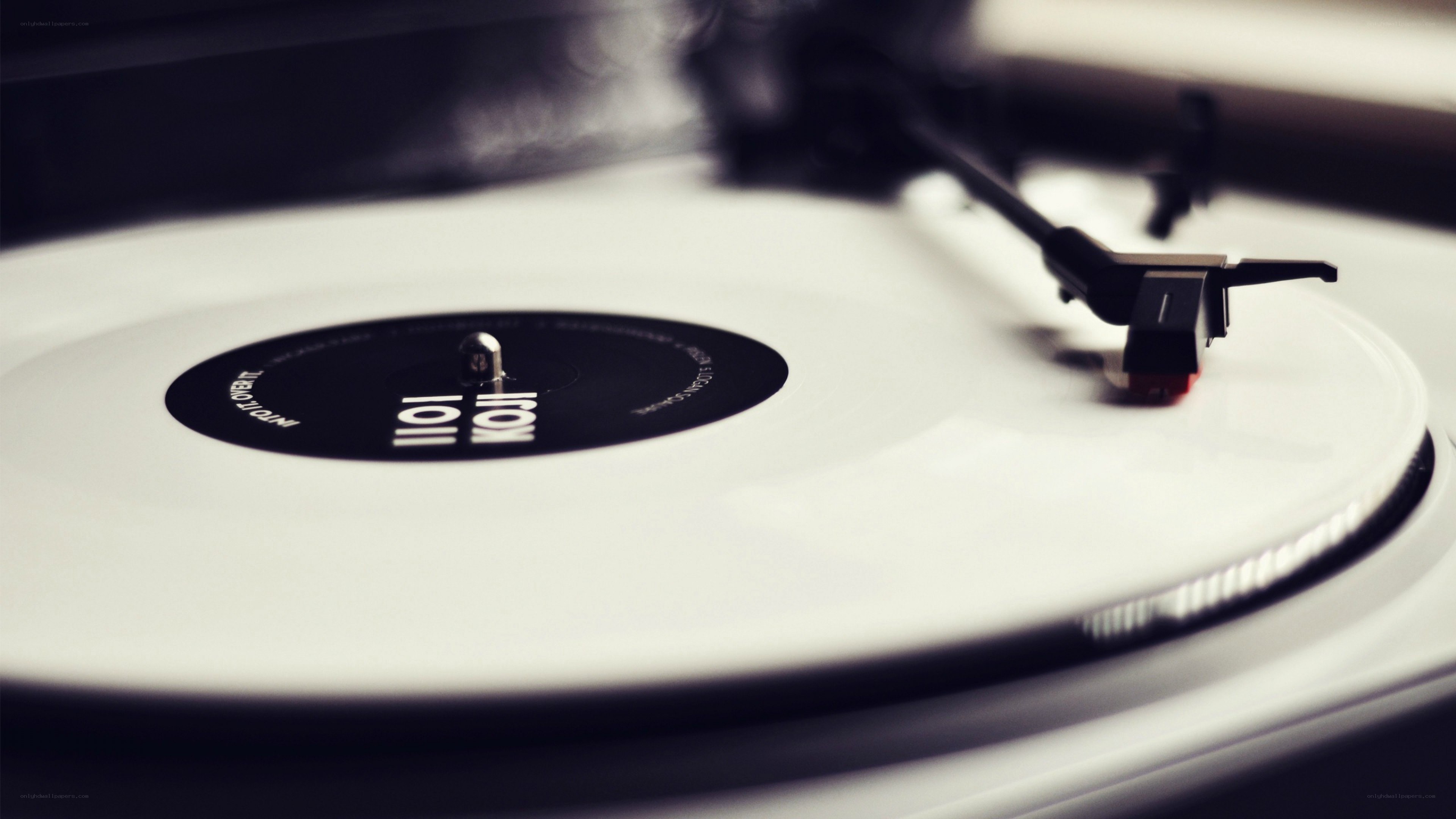 white vinyl record on turntable