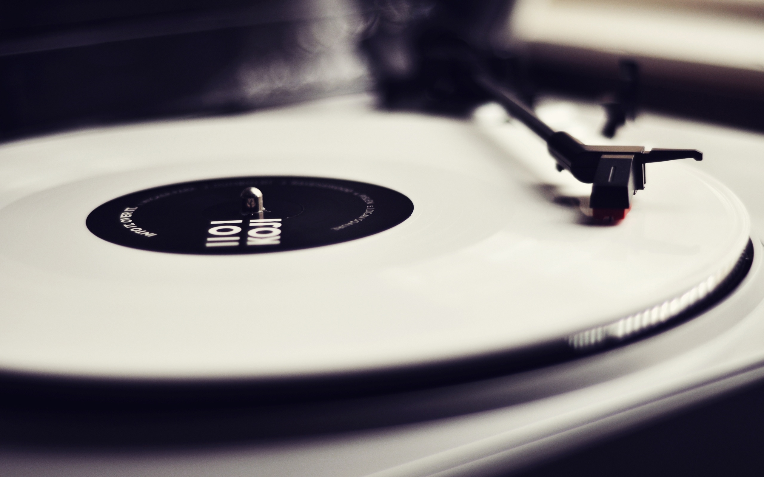 white vinyl record on turntable