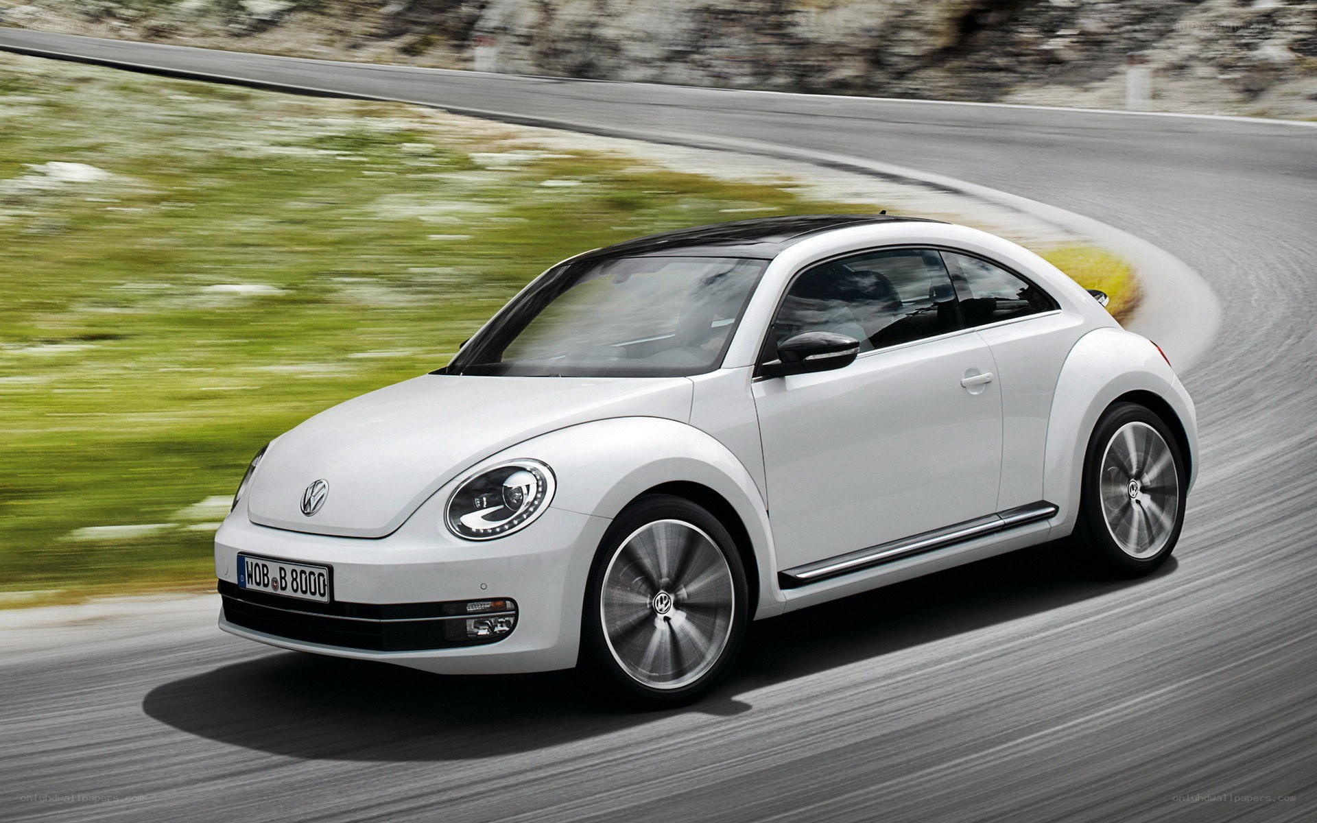 white volkswagen beetle in motion
