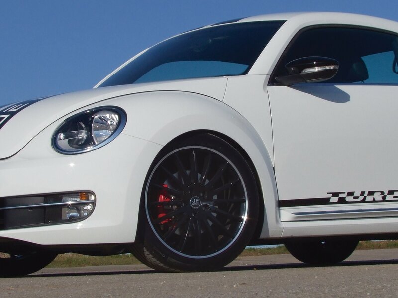 white volkswagen beetle with black wheels