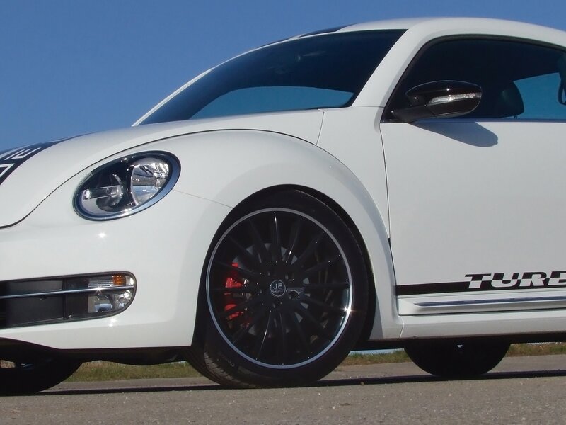 white volkswagen beetle with black wheels