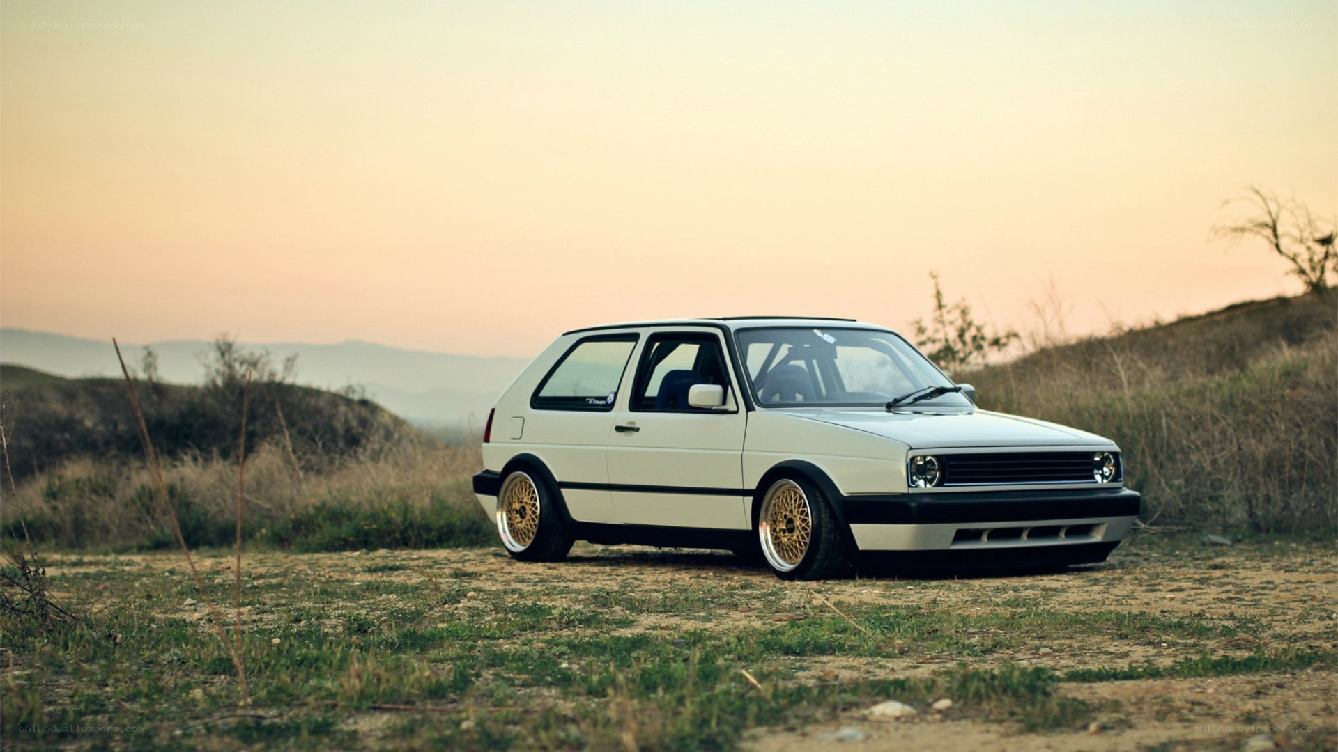 white volkswagen golf at sunset
