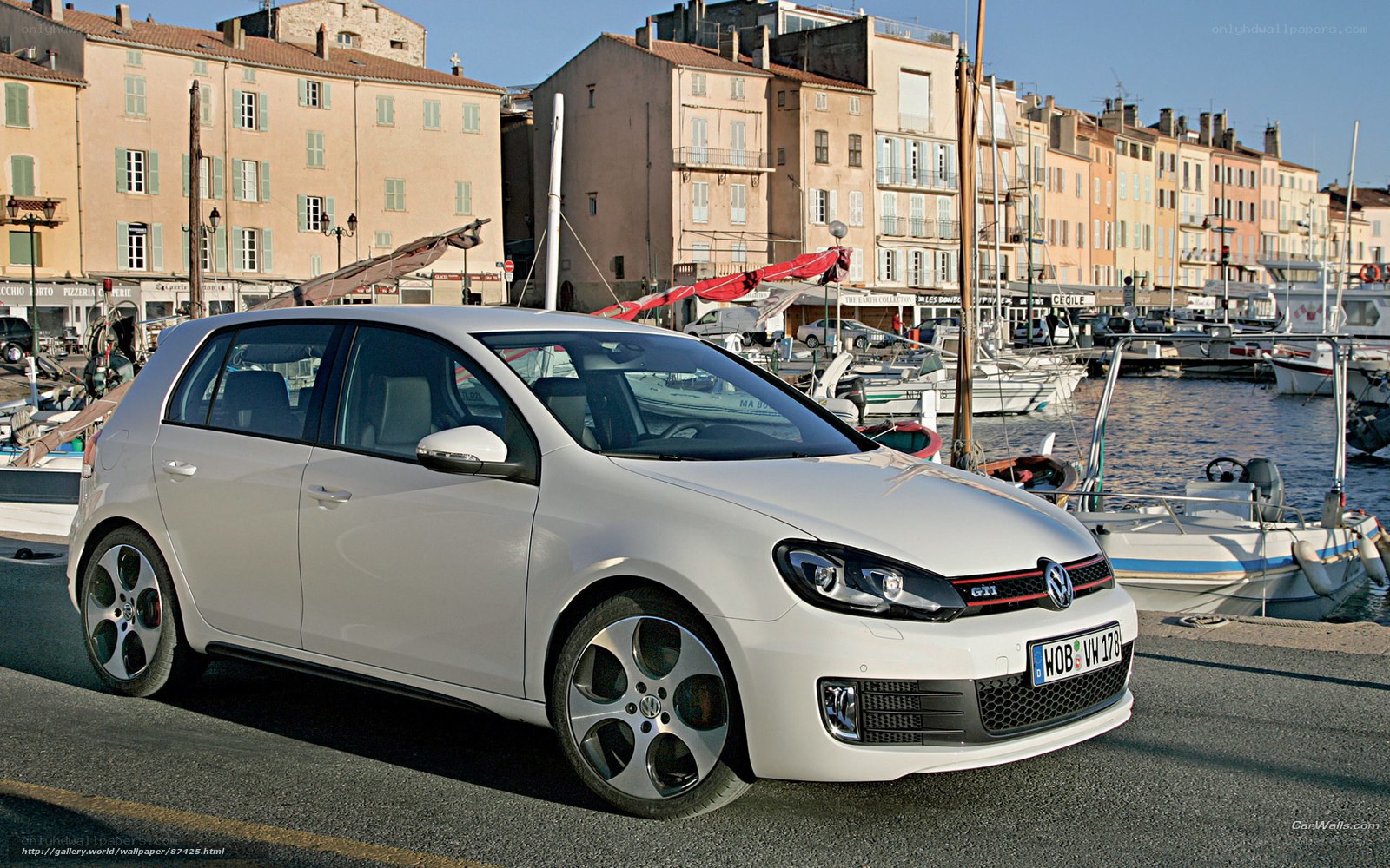 White Volkswagen Golf GTI by the harbor