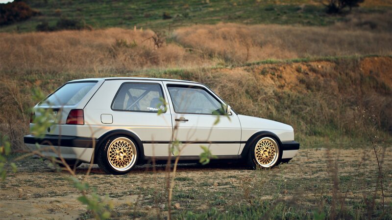 white volkswagen golf in field