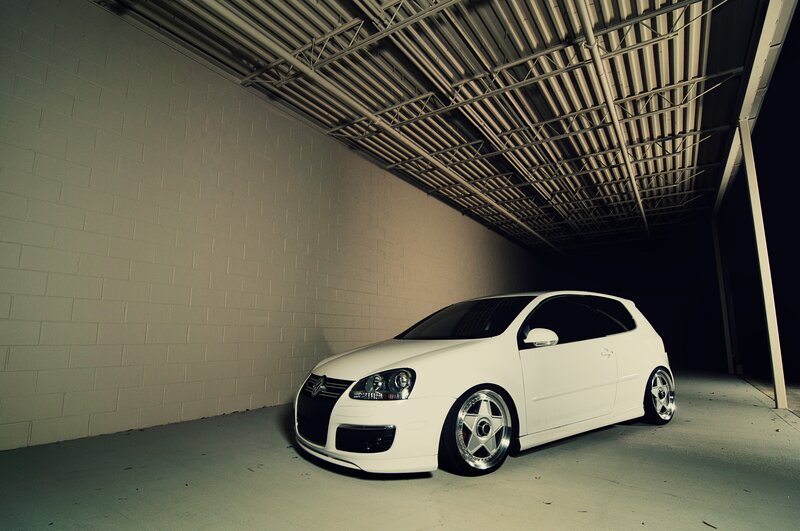 white volkswagen golf in garage