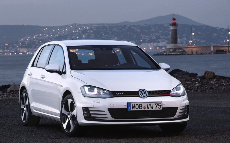 White Volkswagen GTI by the sea