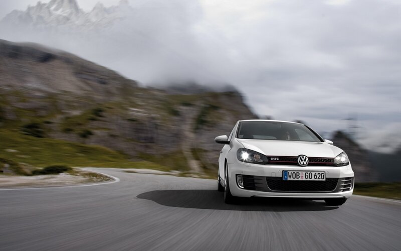 White Volkswagen GTI on mountain road