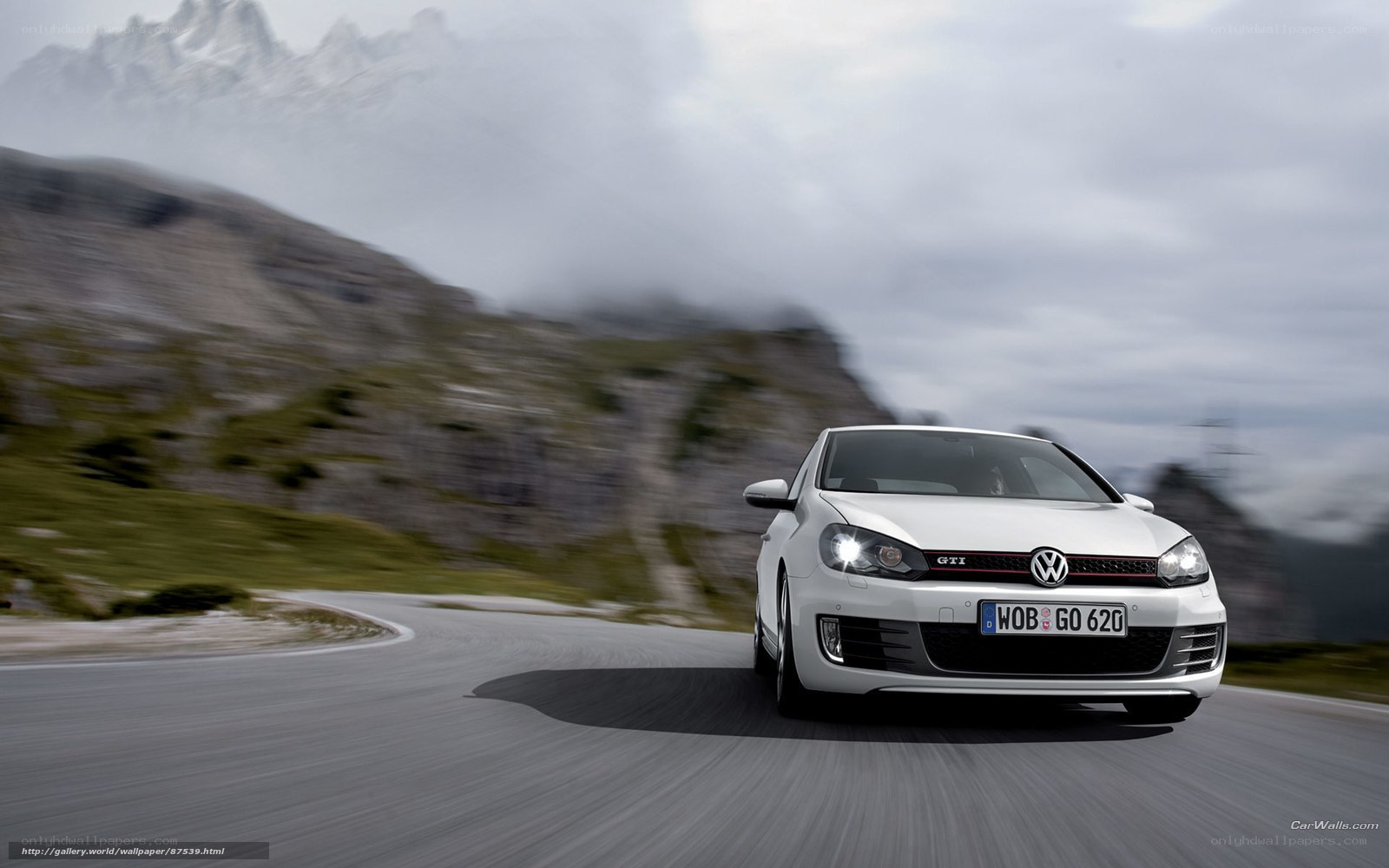 White Volkswagen GTI on mountain road