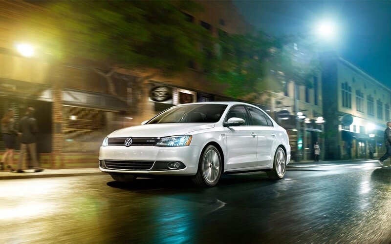White Volkswagen Jetta Hybrid driving at night