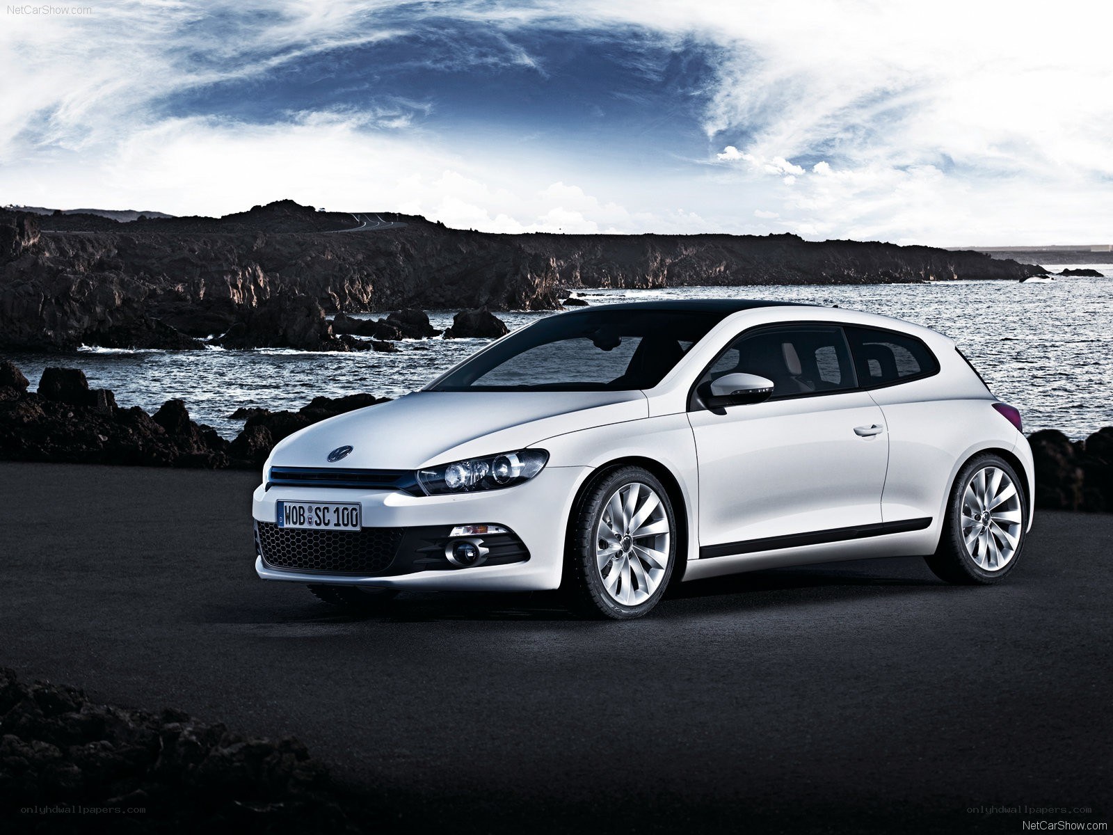White Volkswagen Scirocco by the coast