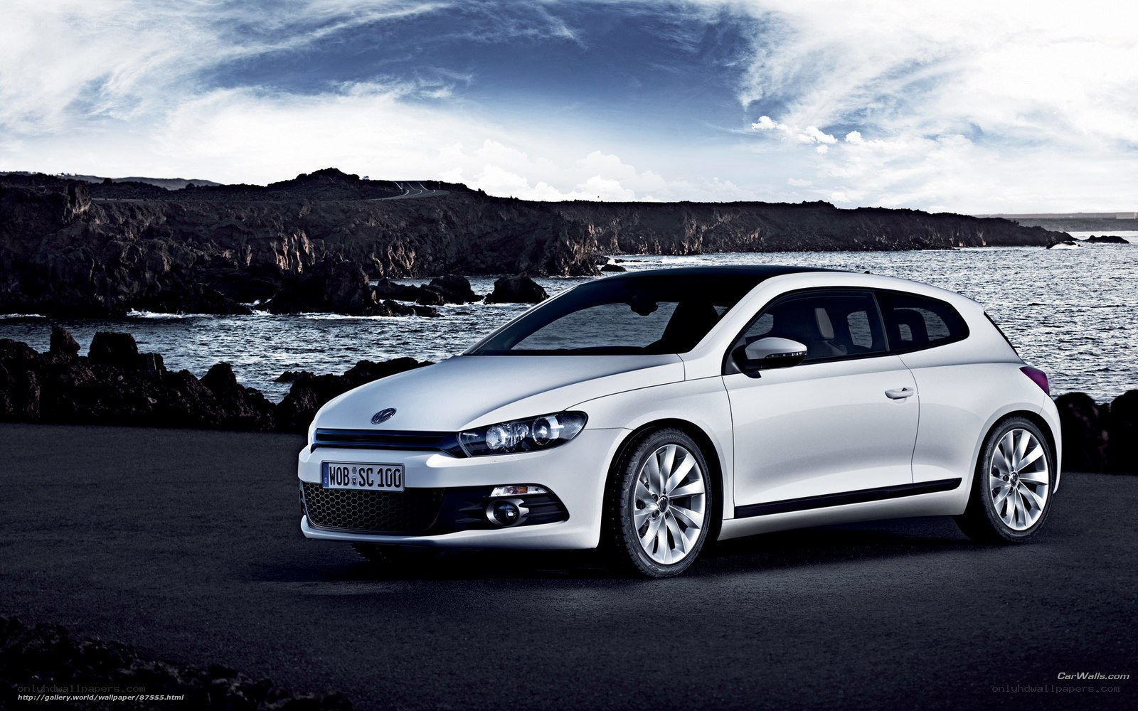 White Volkswagen Scirocco by the coast