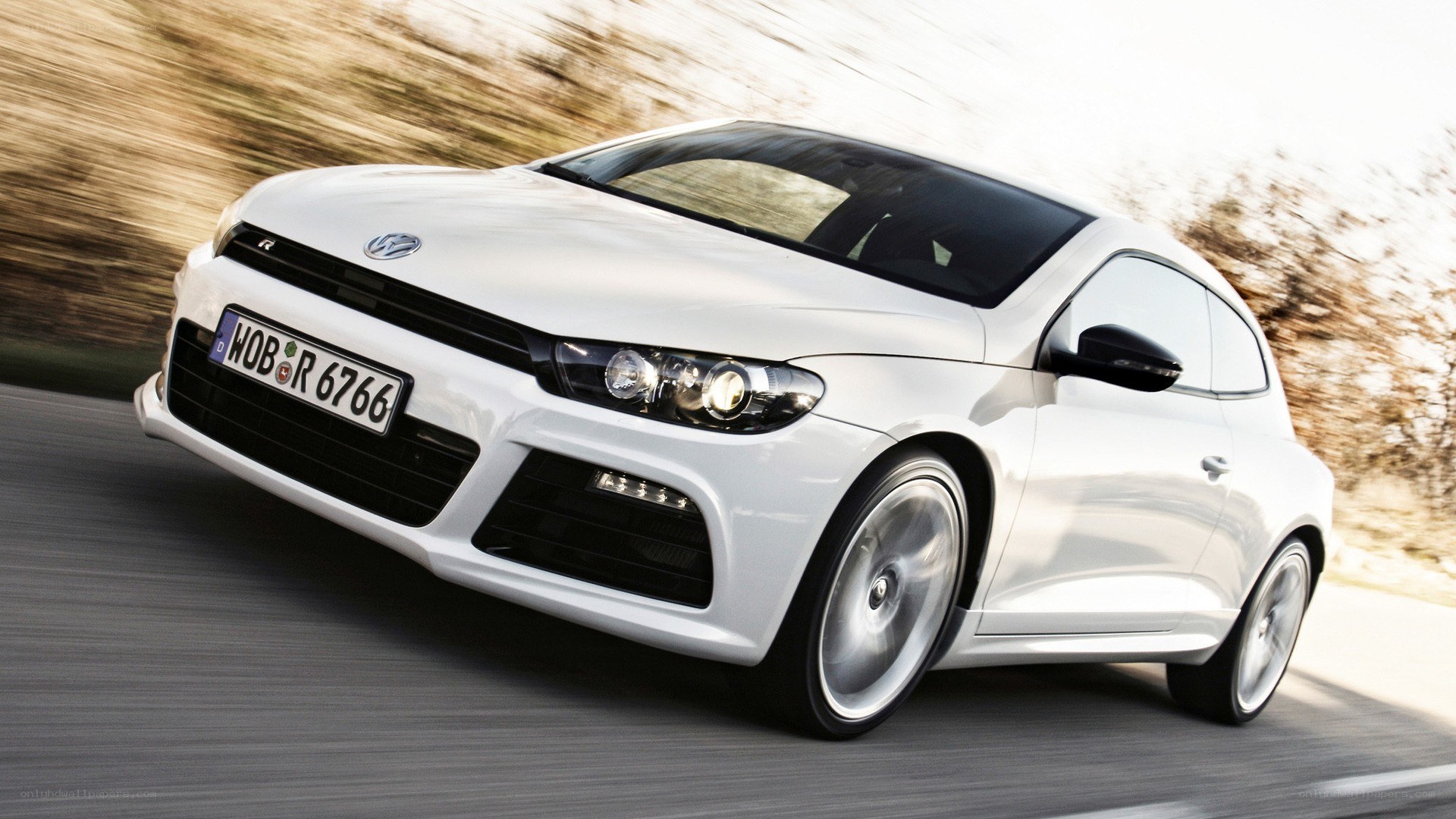 white volkswagen scirocco in motion