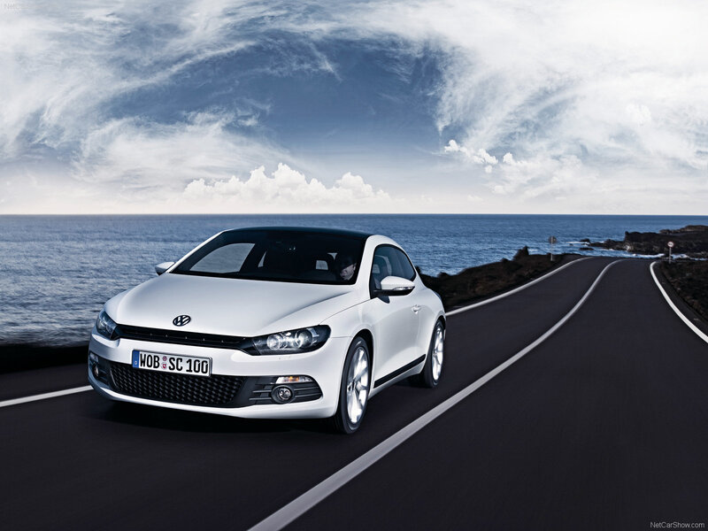 White Volkswagen Scirocco on coastal road