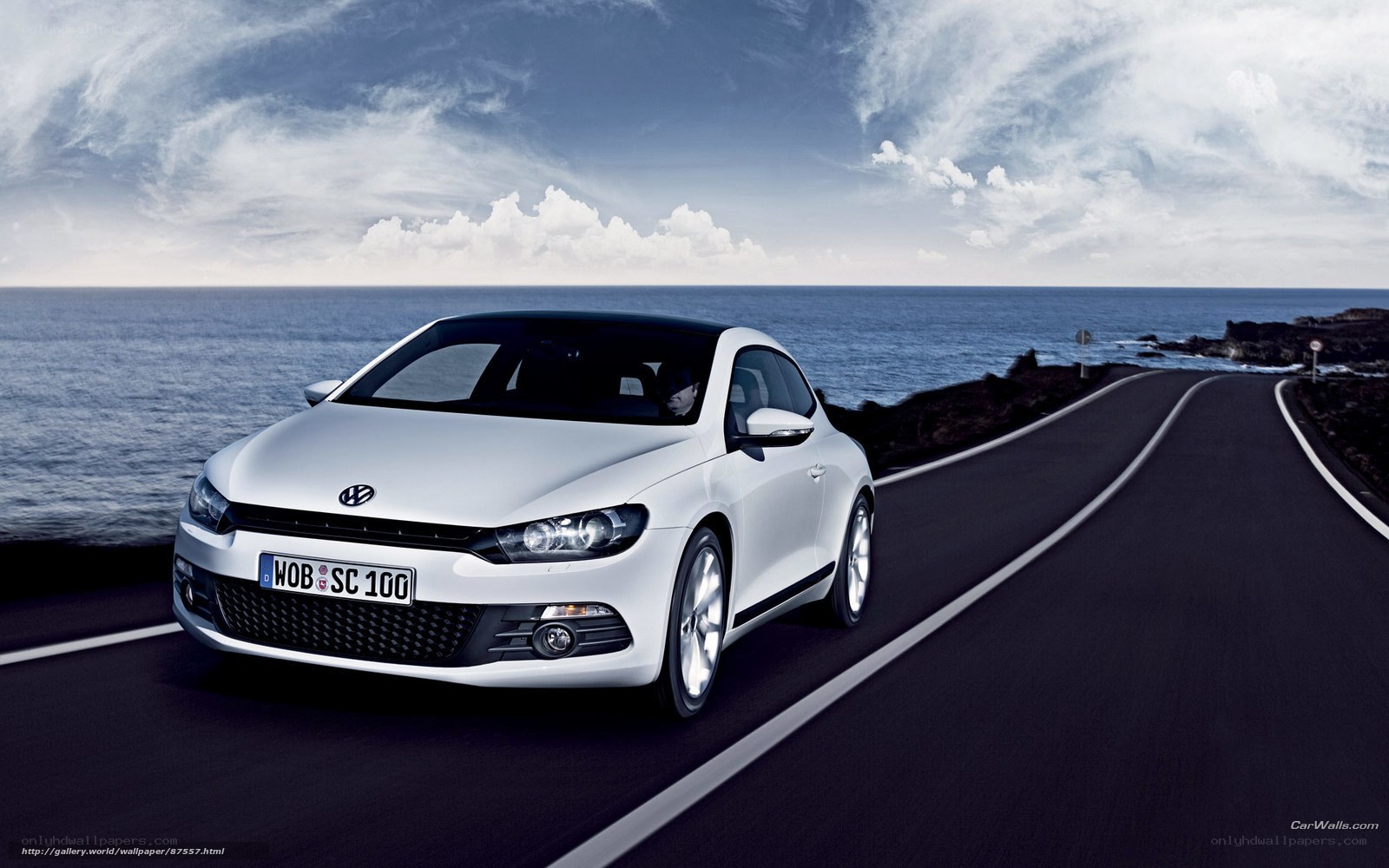 White Volkswagen Scirocco on coastal road