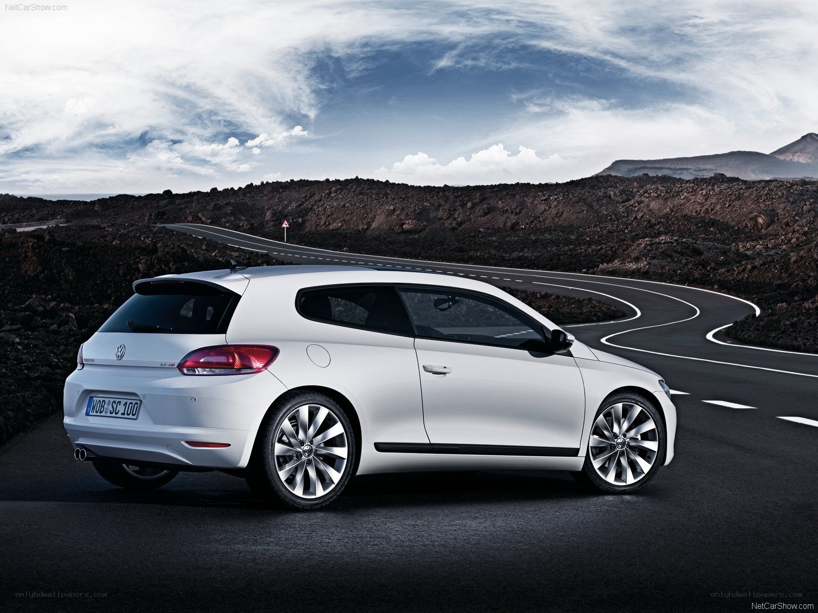 white volkswagen scirocco on winding road
