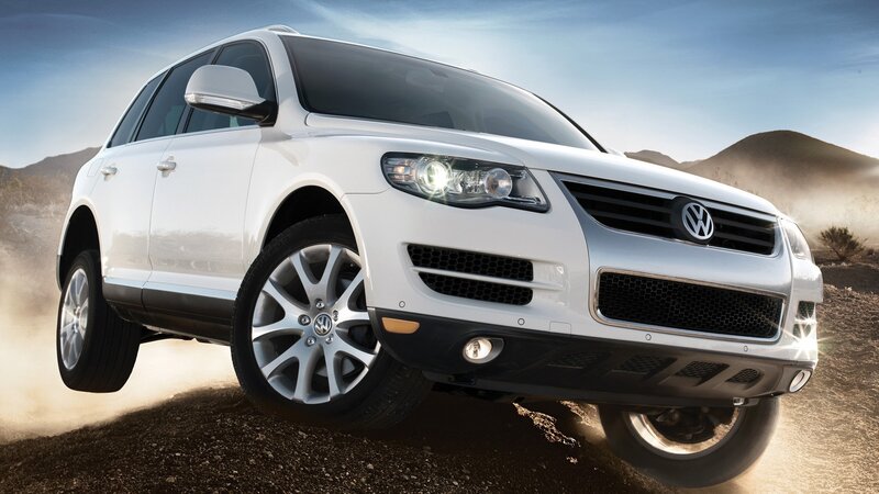 white volkswagen suv on dirt road