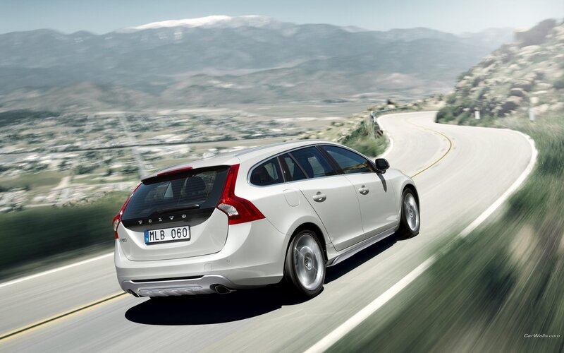 white volvo on winding road