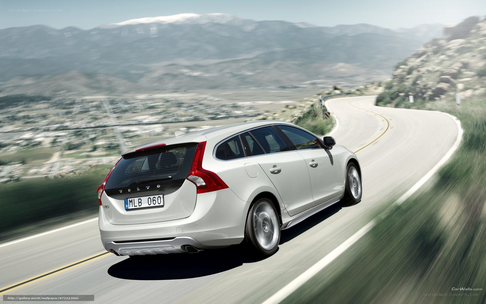 white volvo on winding road
